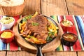 roast beef with seasonings and sliced Ã¢â¬â¹Ã¢â¬â¹barbecue salad served on plate on wooden table Royalty Free Stock Photo